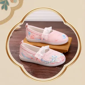 Detail of pink girls' Hanfu shoes with floral embroidery and lace straps