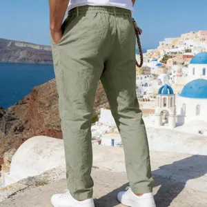 Men's loose linen casual straight trousers in olive green shown from behind