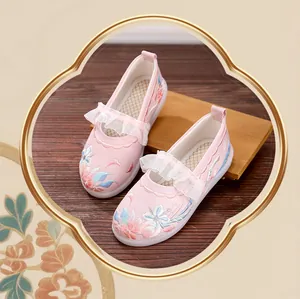 Detailed view of pink girls' Hanfu shoes with floral embroidery and lace straps
