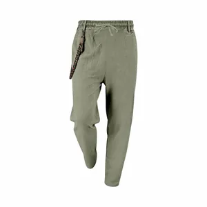 Front view of men's loose olive green linen trousers with drawstring waist and decorative cord