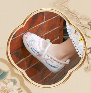 Detailed view of girls' white Hanfu shoes with colorful floral embroidery and lace