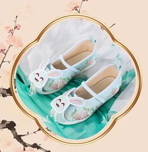 Detailed view of light blue girls' Hanfu shoes featuring 3D rabbit embroidery and pearls.