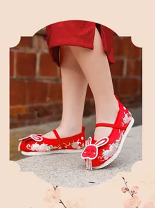 Close-up of red Hanfu embroidered cloth shoes for girls featuring a cute rabbit motif