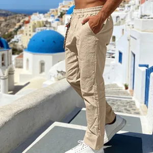 Side view of men's loose linen casual pants in khaki on a Mediterranean background