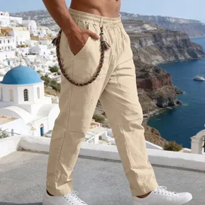 Side view of men's loose beige linen pants with decorative braided chain accessory