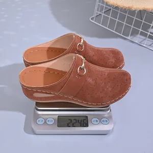 Detail view of brown wedge mule slippers on a scale showing lightweight 224.6g