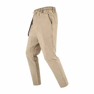 Side view detail showing the texture of men's loose beige linen casual straight-leg trousers.