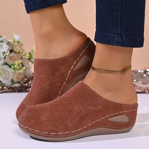 Side view of women's brown closed-toe platform mules with hollow-out patterns