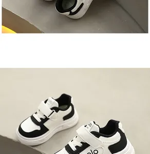 Detailansicht der weiß-schwarzen Kinder-Sneaker mit dicker Sohle und Klettverschluss