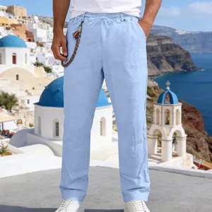 Detail view of light blue men's loose linen casual straight-leg pants against scenery