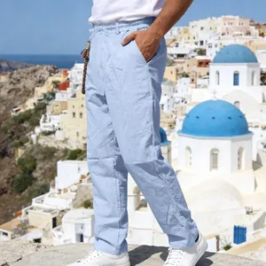 Light blue linen trousers for men with a relaxed straight-leg fit and drawstring waist