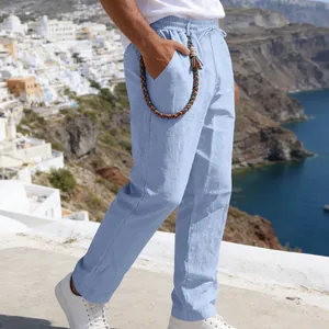 Detailed side view of men's loose light blue linen straight-leg casual trousers for summer.
