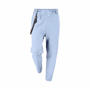 Detailed view of men's loose light blue linen casual trousers with drawstring waist