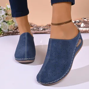 Elegant blue laser-cut floral wedge mules for women with decorative white stitching