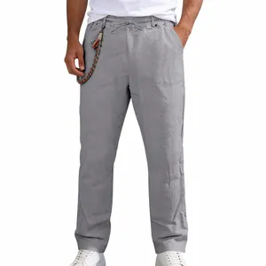 Close-up detail of men's loose linen casual straight pants in elegant light grey