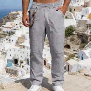 Close-up detail of grey men's loose linen pants showing texture and drawstring waist.