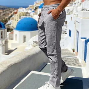 Close-up of men's loose grey linen casual pants with straight leg design for summer.