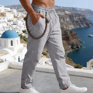 Detailed view of grey linen casual straight trousers featuring a braided rope accessory on model
