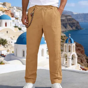 Detail of men's khaki linen trousers showing the loose straight fit and drawstring waist design