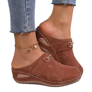 Women's brown thick sole wedge slippers with hollow-out floral pattern and closed-toe.