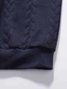 Macro detail of navy blue jacquard diamond fabric and ribbed hem on casual men's top
