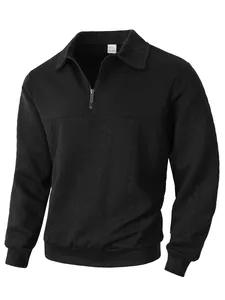 Macro detail of men's black half-zip polo shirt featuring intricate jacquard knit patterns