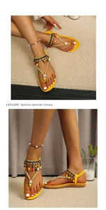 Detailed view of yellow bohemian flat sandals with colorful beads and rhinestone accents