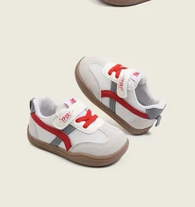 Close-up of toddler walking shoes with breathable mesh, red accents and rubber soles