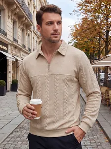 Close-up detail of a premium beige textured half-zip knit polo sweater for men on street
