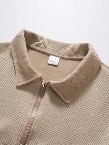 Close-up of men's khaki jacquard polo shirt featuring half-zip and textured collar.