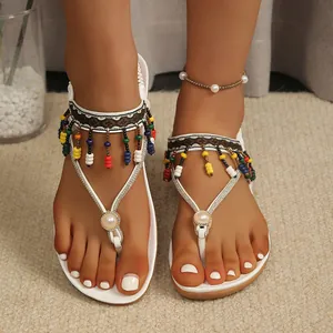 Bohemian white flat thong sandals for women featuring colorful beads and pearl accents
