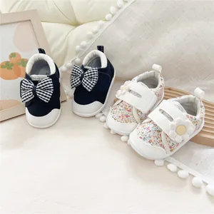 Detailed view of floral pattern and bow accented soft-soled forest style baby walking shoes