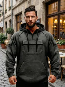 Close-up of tactical charcoal grey hoodie with multiple pockets and drawstring hood.