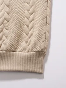 Close-up of beige quilted jacquard fabric and ribbed hem on men's casual polo shirt