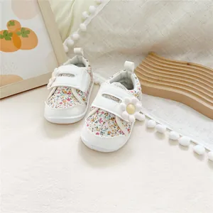 Detail view of floral print Mori style baby soft sole walking shoes with velcro strap