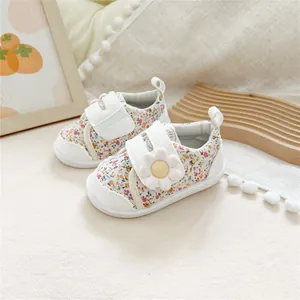 Macro detail of baby soft-sole floral walking shoes featuring a daisy velcro strap
