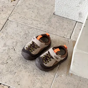Macro view of breathable mesh toddler outdoor shoes featuring brown and beige color tones
