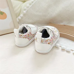 Close-up detail showing floral pattern and velcro strap on baby soft sole walking shoes