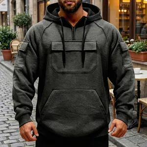 Detail of men's dark grey tactical hoodie with multi-pocket design and drawstring