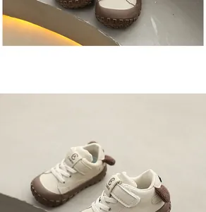 Detailed view of cream-colored toddler walking shoes with soft protective rubber soles