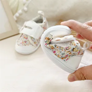 Close-up of flexible soft-sole baby walking shoe with floral pattern for toddlers