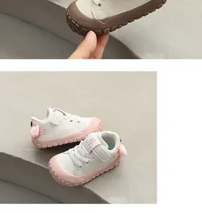 Close-up of baby walking shoes with pink anti-kick rubber toe and rabbit ears