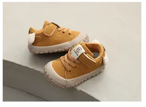 Side view of toddler walking shoes in mustard yellow finish with soft fur heel details