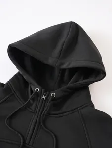 Close-up detail of a solid black casual zip-up hoodie featuring an adjustable drawstring