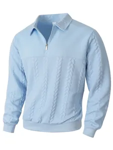 Detail view of light blue men's half-zip polo shirt with jacquard knit texture.