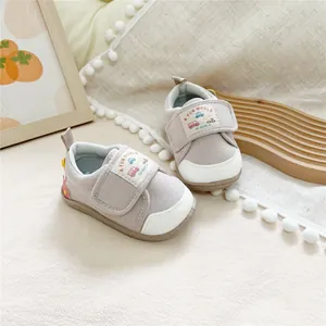 Close-up of baby soft sole walking shoes with car embroidery and velcro straps