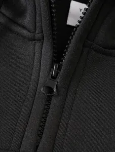 Detailed close-up showing the smooth black metal zipper and ribbed fabric of this hoodie.