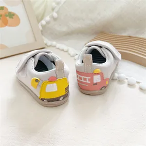 Close-up detail of soft-sole baby walker shoes featuring cute cartoon vehicle heel patterns