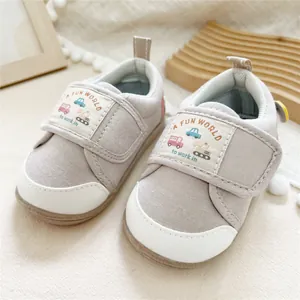 Close-up of grey Mori style baby walking shoes featuring soft soles and hook loops