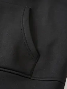 Macro view of kangaroo pocket stitching on a high-quality black hooded sweatshirt